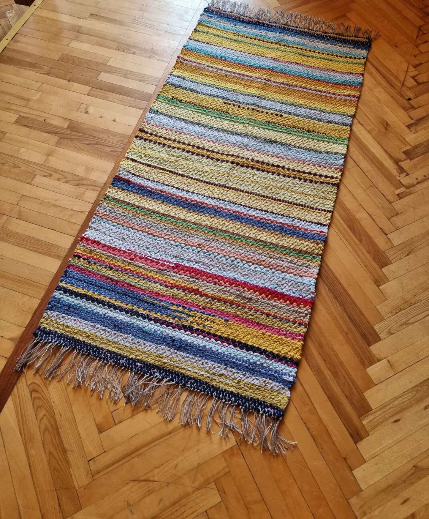 Hand woven floor mat from knitted rags